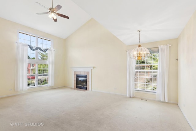 3087 Clifton Ct, Aurora, IL 60504 - unfurnished living room featuring a chandelier, plenty of natural light, a tile fireplace, carpet, and high vaulted ceiling