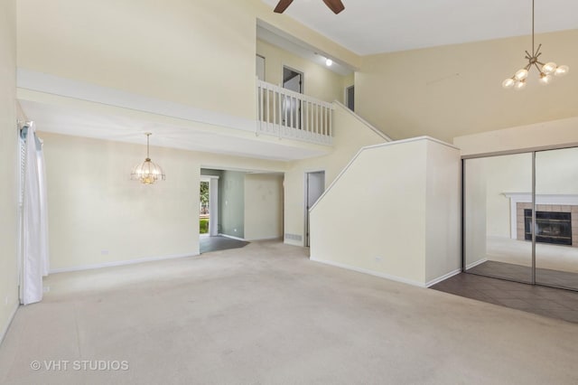 3087 Clifton Ct, Aurora, IL 60504 - unfurnished living room with a chandelier, carpet floors, high vaulted ceiling, a fireplace, and a ceiling fan