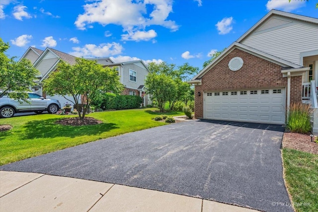 16 Christie Ct Unit 16, Algonquin, IL 60102 - view of side of home featuring brick siding, asphalt driveway, a yard, and an attached garage