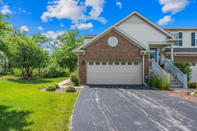 16 Christie Ct Unit 16, Algonquin, IL 60102 - view of front facade featuring asphalt driveway, brick siding, a front yard, and an attached garage