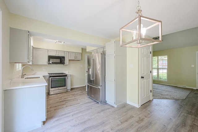 413 Channel Dr, Island Lake, IL 60042 - kitchen with stainless steel appliances, light wood-type flooring, gray cabinets, light countertops, and a chandelier