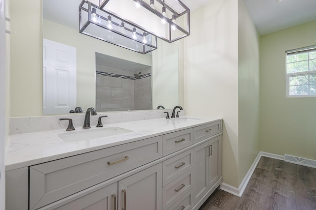 413 Channel Dr, Island Lake, IL 60042 - full bathroom featuring double vanity, wood finished floors, and tiled shower