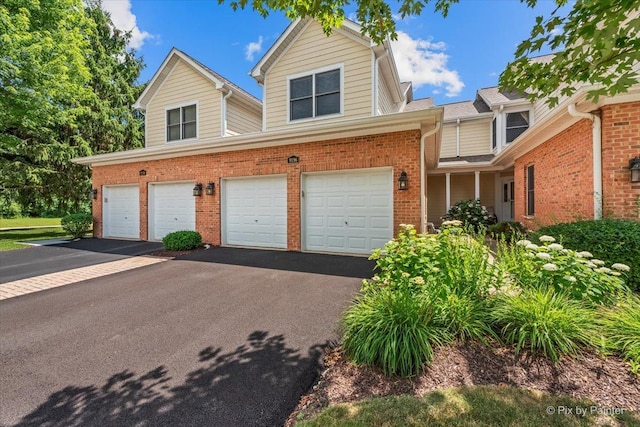 9196 Falcon Greens Dr, Lakewood, IL 60014 - traditional home featuring an attached garage, brick siding, and asphalt driveway