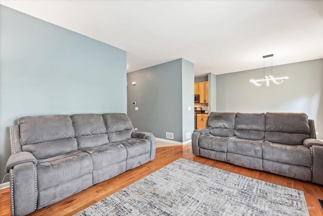 9196 Falcon Greens Dr, Lakewood, IL 60014 - living area with a chandelier and light wood finished floors