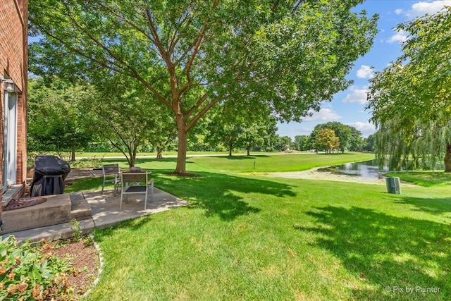 9196 Falcon Greens Dr, Lakewood, IL 60014 - view of green lawn with a water view and a patio area