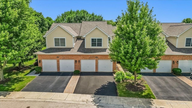 9196 Falcon Greens Dr, Lakewood, IL 60014 - view of front of property with driveway, brick siding, a shingled roof, and a garage