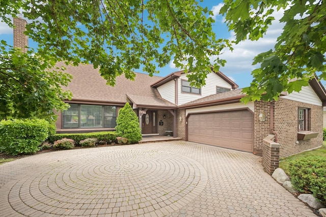 2425 N Drury Ln, Arlington Heights, IL 60004 - traditional-style house featuring an attached garage, brick siding, and curved driveway