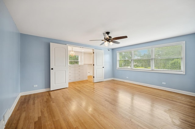 2425 N Drury Ln, Arlington Heights, IL 60004 - unfurnished bedroom featuring multiple windows, light wood-style floors, and ceiling fan