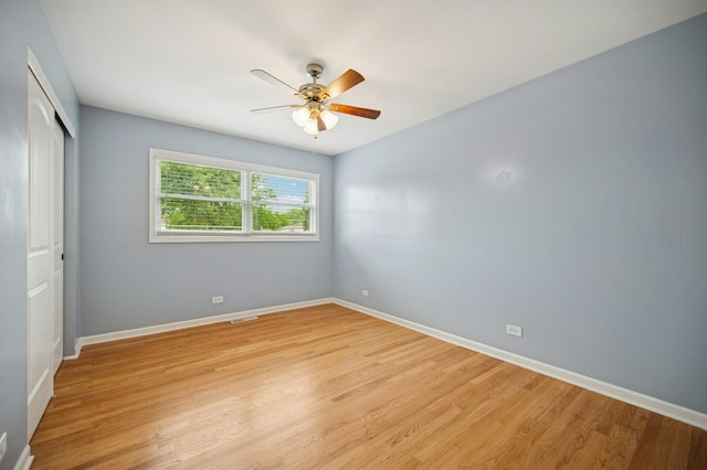 2425 N Drury Ln, Arlington Heights, IL 60004 - unfurnished bedroom with a closet, light wood finished floors, and ceiling fan