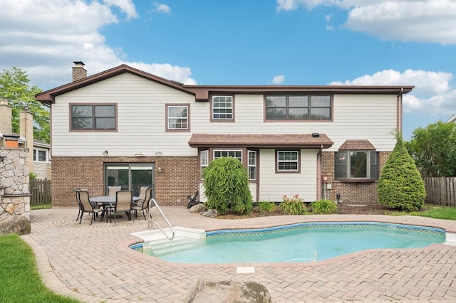 2425 N Drury Ln, Arlington Heights, IL 60004 - rear view of property with brick siding, a patio, and a chimney