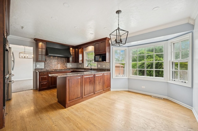 2425 N Drury Ln, Arlington Heights, IL 60004 - kitchen featuring wall chimney exhaust hood, a chandelier, black microwave, a peninsula, and ornamental molding