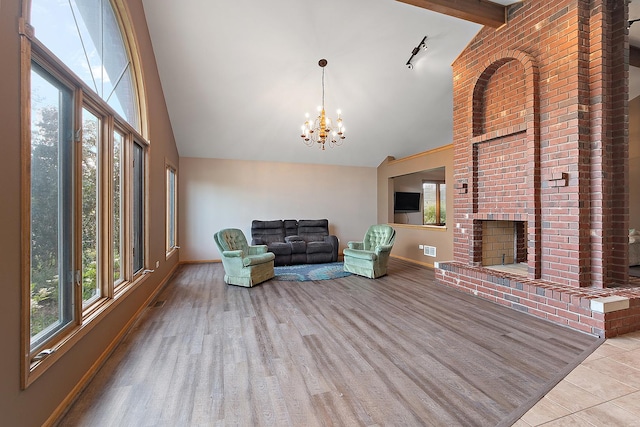 8542 Monaghan Dr, Tinley Park, IL 60487 - living area with high vaulted ceiling, a chandelier, a fireplace, and tile patterned floors