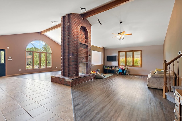 8542 Monaghan Dr, Tinley Park, IL 60487 - living area featuring healthy amount of natural light, beam ceiling, a fireplace, ceiling fan, and stairway