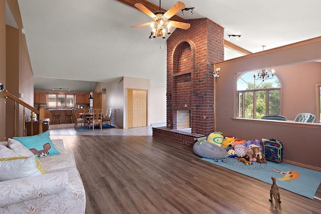 8542 Monaghan Dr, Tinley Park, IL 60487 - living room with wood finished floors, a high ceiling, a fireplace, a ceiling fan, and healthy amount of natural light