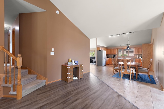 8542 Monaghan Dr, Tinley Park, IL 60487 - dining area featuring track lighting, high vaulted ceiling, light wood-style floors, and stairway