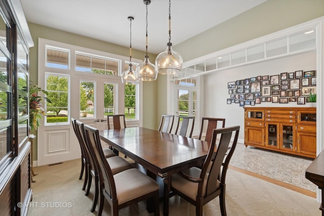 6531 W Cedar Ct, Monee, IL 60449 - dining area featuring french doors, light carpet, and a chandelier