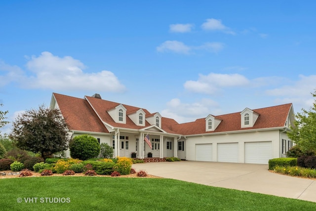 6531 W Cedar Ct, Monee, IL 60449 - cape cod house featuring covered porch, a garage, concrete driveway, a front lawn, and a chimney