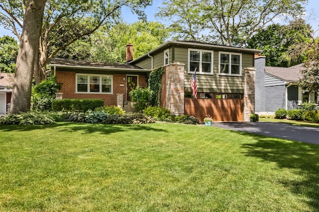 228 S Glendale Ave, Barrington, IL 60010 - tri-level home with asphalt driveway, a garage, brick siding, a chimney, and a front yard