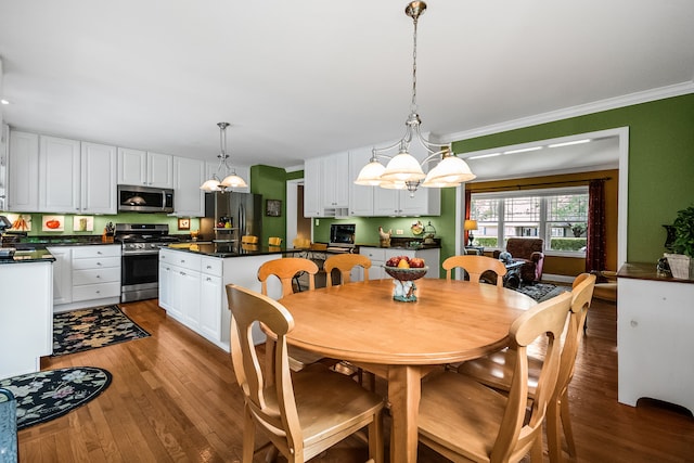 228 S Glendale Ave, Barrington, IL 60010 - dining room with wood finished floors, a chandelier, and crown molding