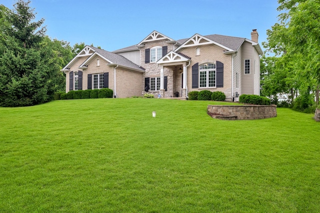 18013 Saint Andrews Dr, Marengo, IL 60152 - craftsman inspired home with a chimney, a front yard, and stone siding
