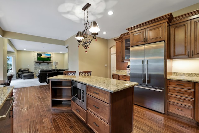 18013 Saint Andrews Dr, Marengo, IL 60152 - kitchen featuring built in appliances, a center island, glass insert cabinets, light stone countertops, and recessed lighting