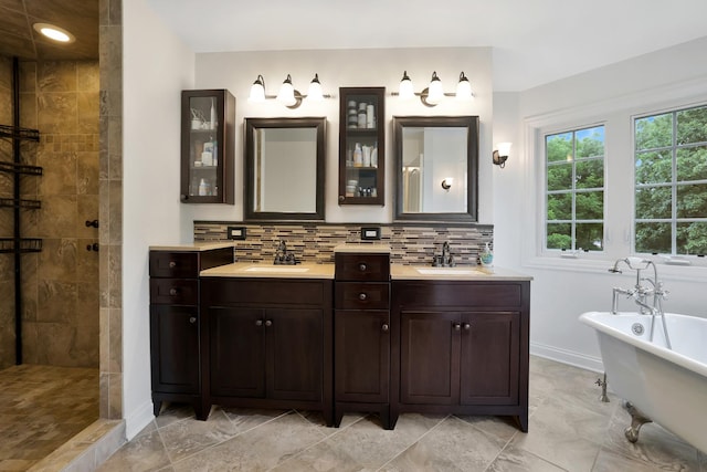 18013 Saint Andrews Dr, Marengo, IL 60152 - bathroom with double vanity, a soaking tub, tiled shower, and backsplash