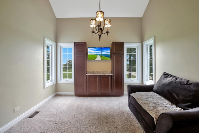 18013 Saint Andrews Dr, Marengo, IL 60152 - sitting room with high vaulted ceiling, a chandelier, and light colored carpet