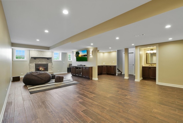 18013 Saint Andrews Dr, Marengo, IL 60152 - living area with dark wood-style floors, a fireplace, recessed lighting, and stairs