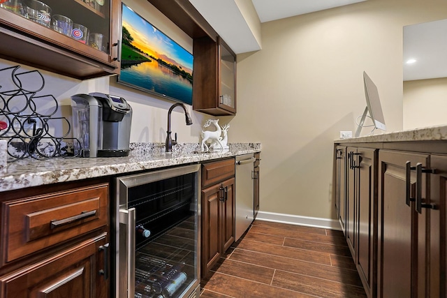 18013 Saint Andrews Dr, Marengo, IL 60152 - kitchen featuring beverage cooler, dark wood-type flooring, light stone countertops, glass insert cabinets, and recessed lighting