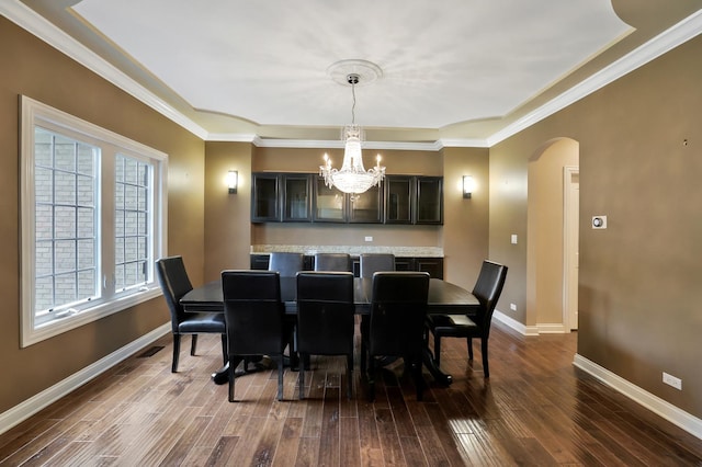 18013 Saint Andrews Dr, Marengo, IL 60152 - dining area with arched walkways, a chandelier, dark wood-type flooring, and ornamental molding