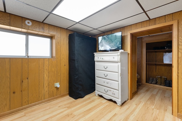 1314 Wesley Ave, Berwyn, IL 60402 - unfurnished bedroom featuring a paneled ceiling, wood walls, and wood finished floors