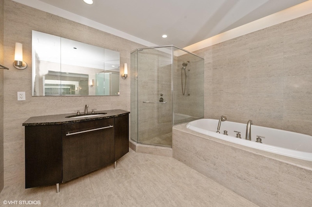 401 N Wabash Ave Unit 33Ab, Chicago, IL 60611 - bathroom featuring vanity, tile walls, a bath, a stall shower, and recessed lighting