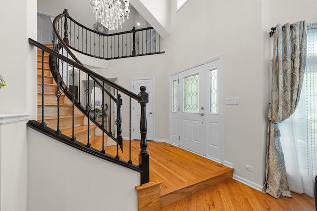 290 Knox Park Rd, Lake Zurich, IL 60047 - entrance foyer with wood finished floors, a chandelier, plenty of natural light, stairs, and a high ceiling