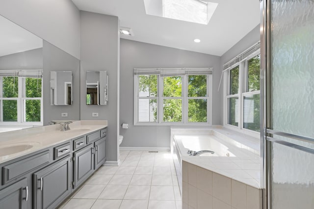 290 Knox Park Rd, Lake Zurich, IL 60047 - bathroom featuring vaulted ceiling, double vanity, a garden tub, tile patterned floors, and a skylight