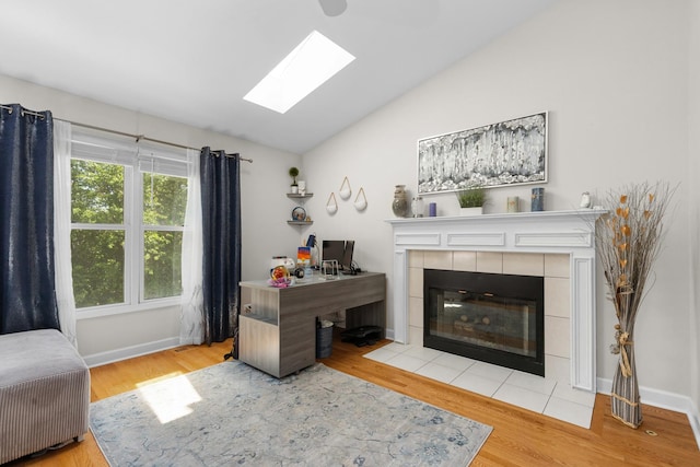 290 Knox Park Rd, Lake Zurich, IL 60047 - living area featuring lofted ceiling, a skylight, wood finished floors, and a tiled fireplace