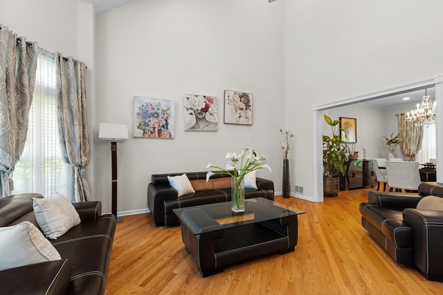 290 Knox Park Rd, Lake Zurich, IL 60047 - living area with a towering ceiling, healthy amount of natural light, a chandelier, and light wood-style flooring