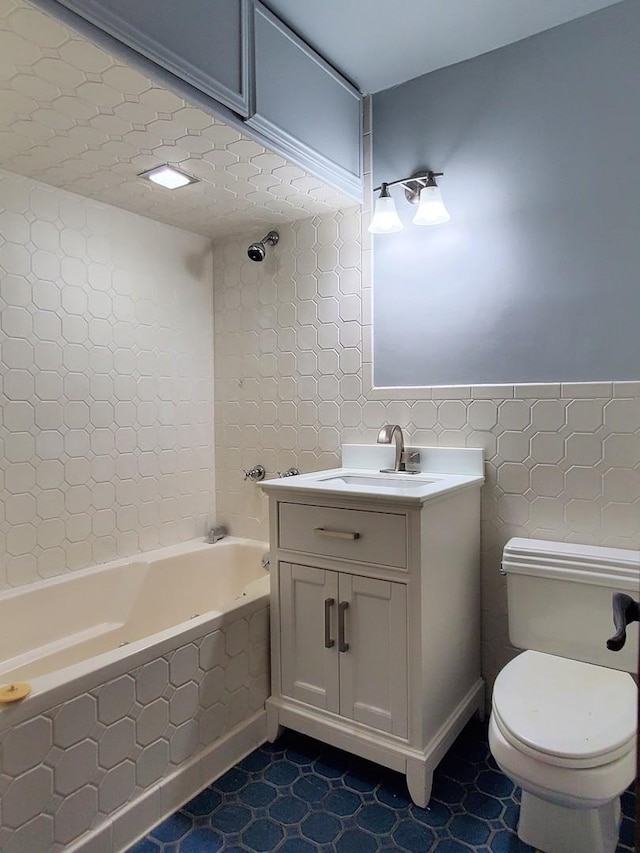 595 W Elk Grove Blvd, Elk Grove Village, IL 60007 - full bathroom featuring vanity, tile walls, and washtub / shower combination
