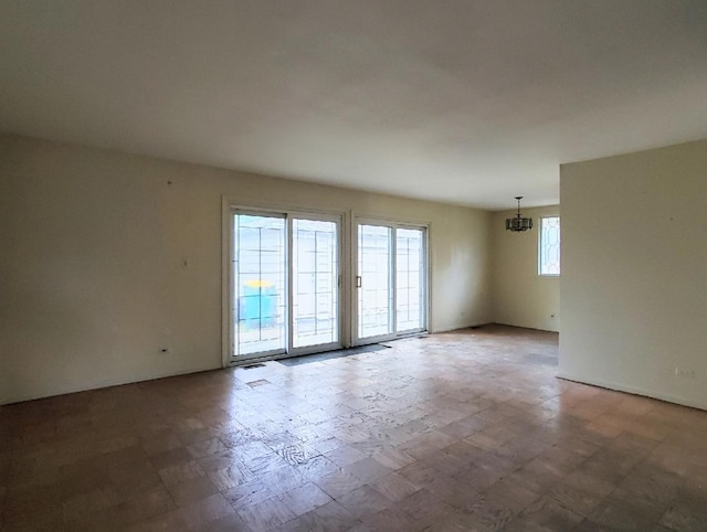 595 W Elk Grove Blvd, Elk Grove Village, IL 60007 - unfurnished room with a chandelier and tile patterned floors