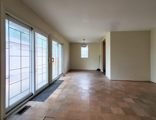 595 W Elk Grove Blvd, Elk Grove Village, IL 60007 - spare room featuring a chandelier and light flooring