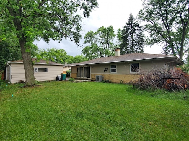 595 W Elk Grove Blvd, Elk Grove Village, IL 60007 - rear view of property featuring a chimney, a lawn, and brick siding