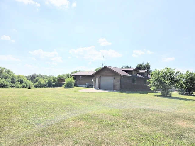 1928 Hidden Valley Dr, Lanark, IL 61046 - view of grassy yard featuring a garage and concrete driveway