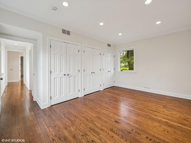 622 Kenilworth Ave, Kenilworth, IL 60043 - unfurnished bedroom with two closets, wood finished floors, recessed lighting, and crown molding
