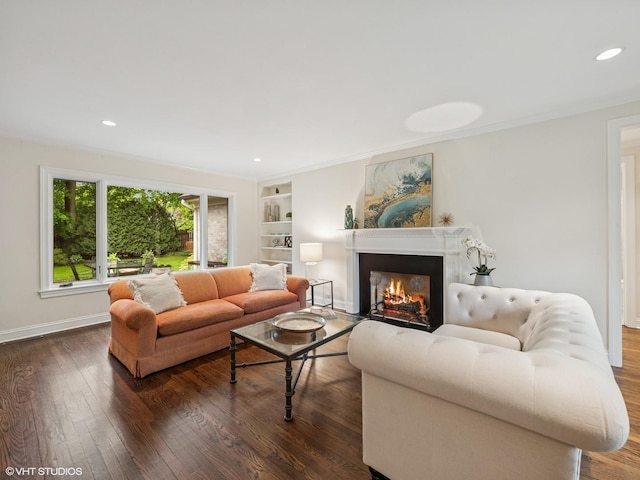 622 Kenilworth Ave, Kenilworth, IL 60043 - living room with dark wood-type flooring, a warm lit fireplace, recessed lighting, built in features, and ornamental molding