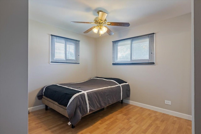 8255 Lockwood Ave, Burbank, IL 60459 - bedroom with multiple windows, light wood-style flooring, and a ceiling fan