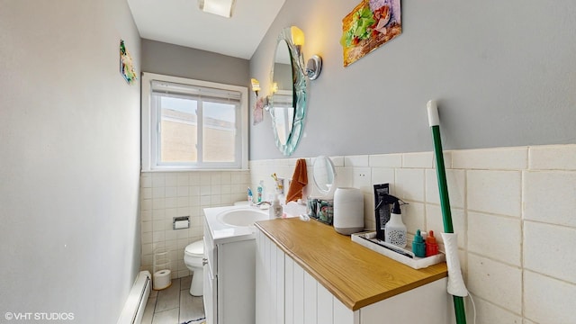 8824 Cherry Ave, River Grove, IL 60171 - bathroom featuring tile walls, vanity, a baseboard heating unit, tile patterned flooring, and a wainscoted wall