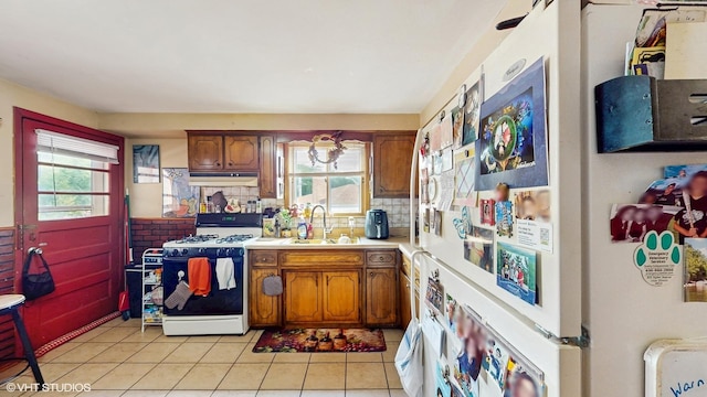 8824 Cherry Ave, River Grove, IL 60171 - kitchen featuring white gas range, light countertops, and brown cabinetry