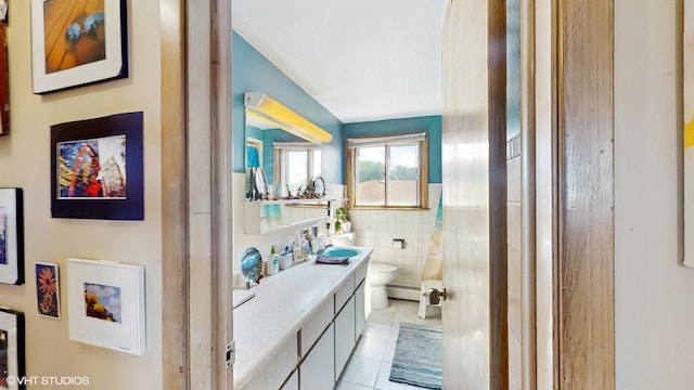 8824 Cherry Ave, River Grove, IL 60171 - full bath with tile patterned flooring, tile walls, vanity, wainscoting, and a baseboard heating unit