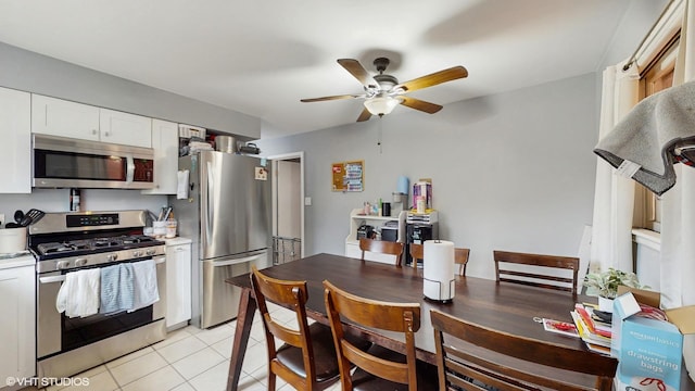 8824 Cherry Ave, River Grove, IL 60171 - kitchen with appliances with stainless steel finishes, a ceiling fan, white cabinetry, light tile patterned floors, and light countertops