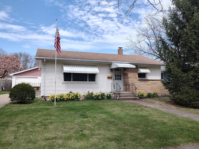 406 Highland St, Belvidere, IL 61008 - view of front of house featuring a chimney, a front yard, an attached garage, a shingled roof, and stone siding