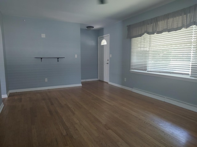 406 Highland St, Belvidere, IL 61008 - unfurnished living room featuring wood finished floors and a baseboard radiator